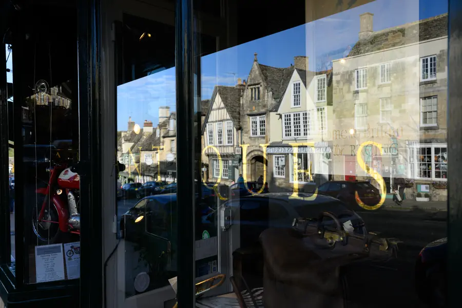 Burford High Street reflected in a shop window